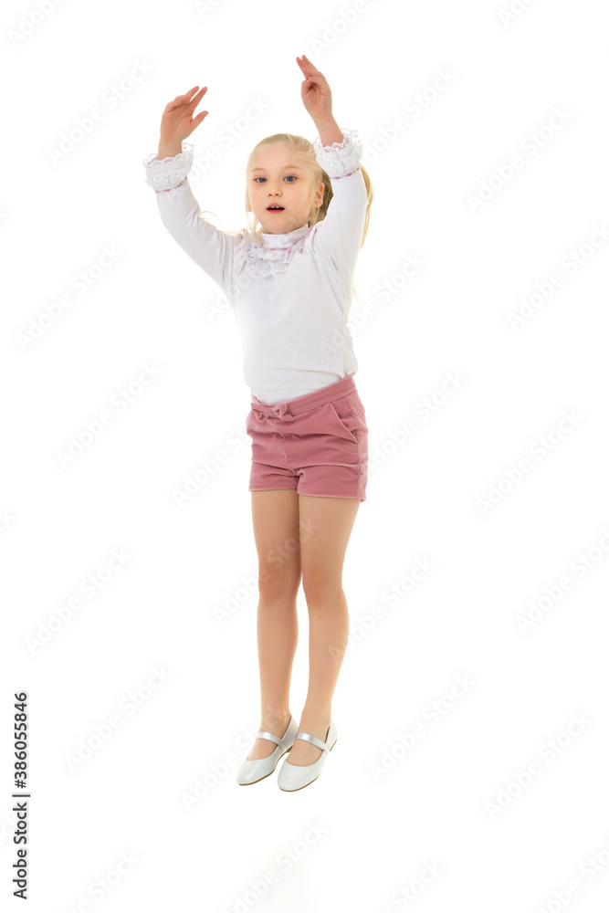 The little girl is jumping fun.The concept of a good mood, summer vacation. The little girl is jumping fun.The concept of a good mood, summer vacation.