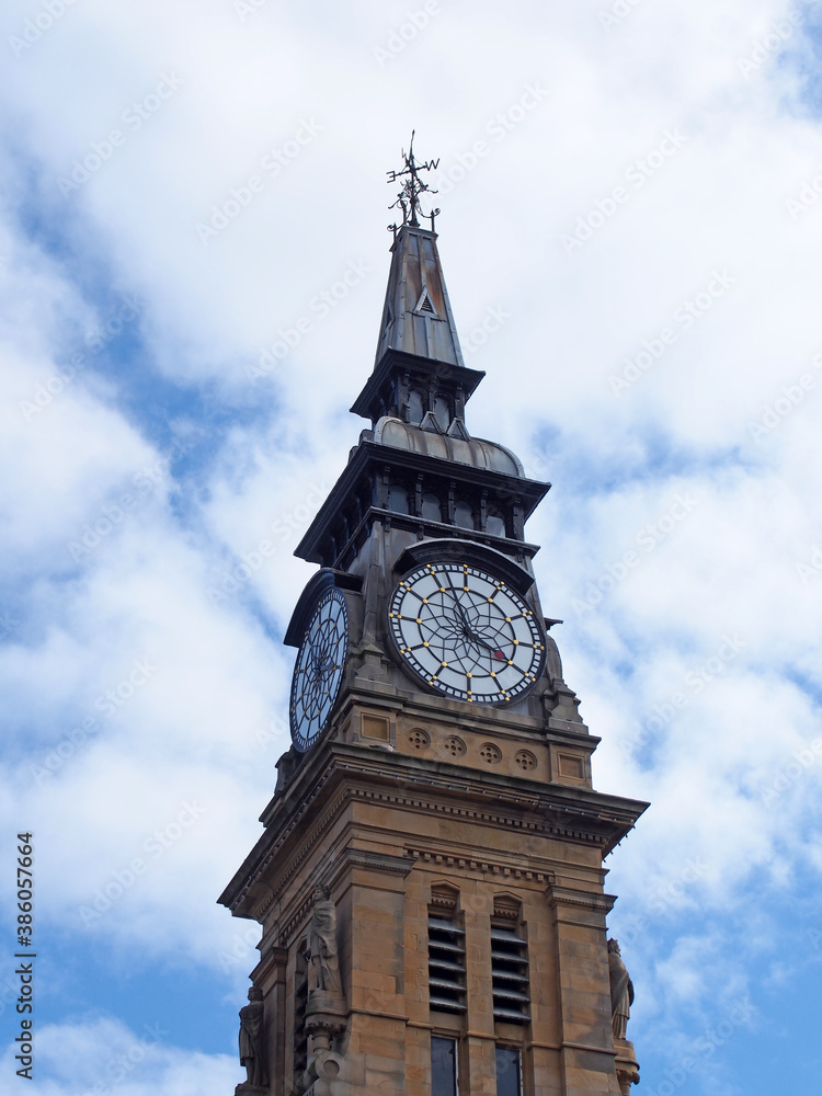 the clock tower of the historic victorian atkinson building in southport merseyside against a blue summer sky
