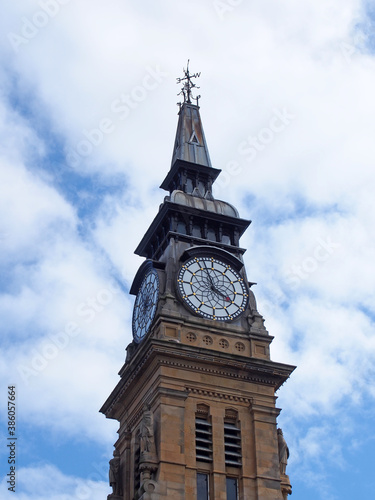 the clock tower of the historic victorian atkinson building in southport merseyside against a blue summer sky