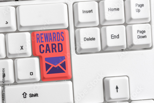 Handwriting text Rewards Card. Conceptual photo Help earn cash points miles from everyday purchase Incentives Different colored keyboard key with accessories arranged on empty copy space photo