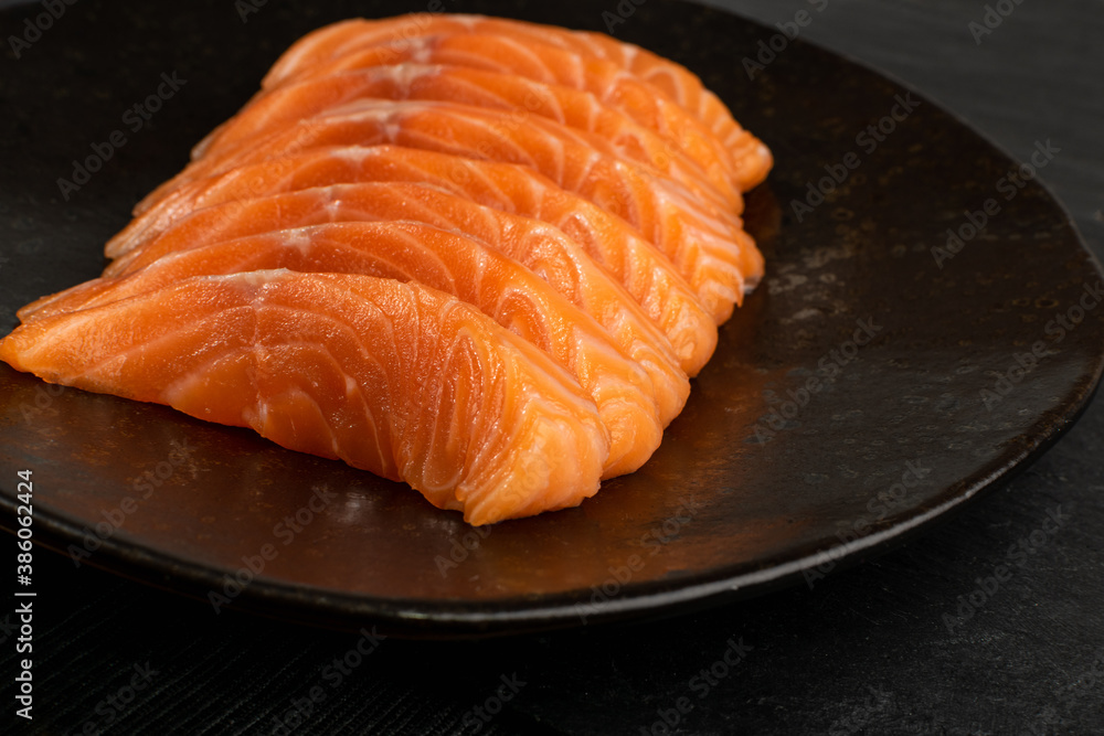 Slices of Raw Salmon Fillet on Black Background Mockup Top View Slices of Raw Salmon Fillet on Black Background Mockup Top View