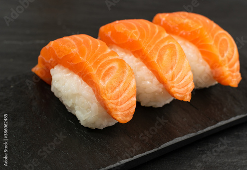 Slices of Raw Salmon Fillet on Black Background Mockup Top View