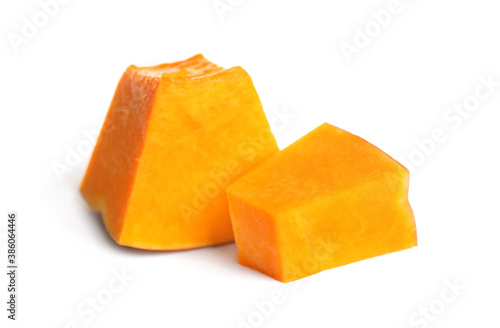 Pieces of ripe orange pumpkin on white background