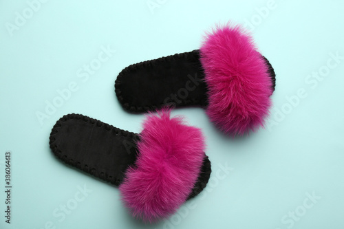 Pair of soft slippers on light blue background, flat lay