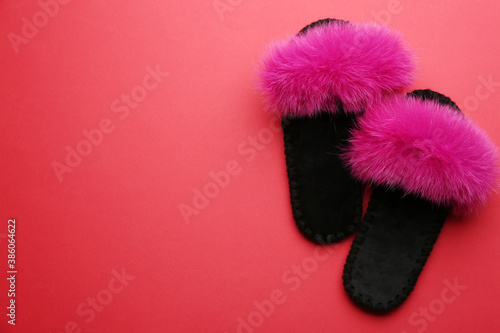 Pair of soft slippers on red background, flat lay. Space for text