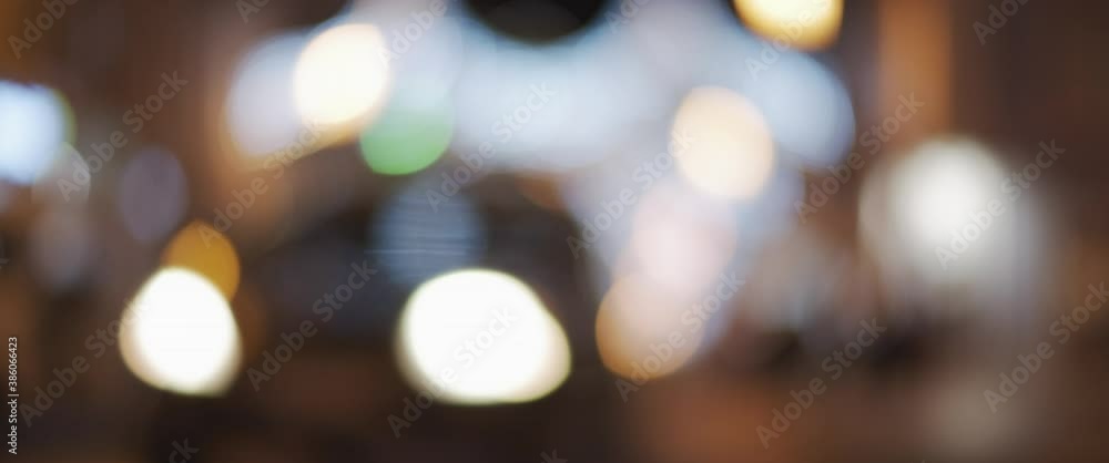 Defocused decoration and traffic lights of a night city during Christmas holiday season. Slow motion, close up, shallow focus. Defocused decoration and traffic lights of a night city during Christmas holiday season. Slow motion, close up, shallow focus.