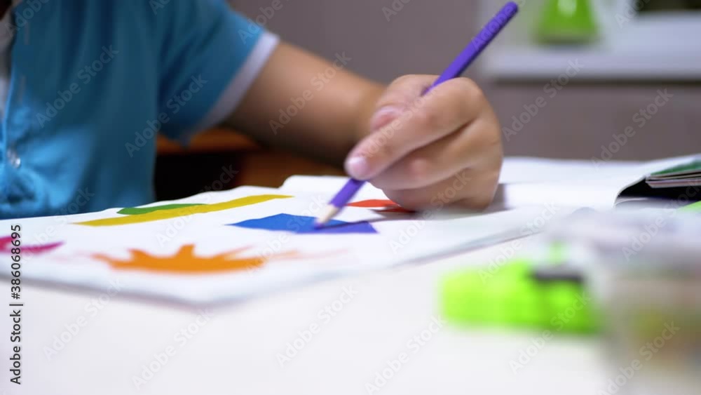 Hand Child Draws with Colored Pencils at Home. Home Schooling, Education Concept Hand Child Draws with Colored Pencils at Home. Home Schooling, Education Concept