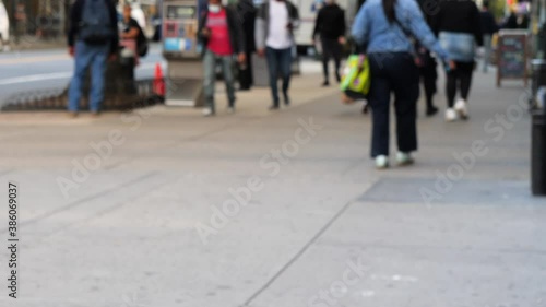 unrecognized blurry image of NYC, people walking to go shopping and commuting at nine weather day