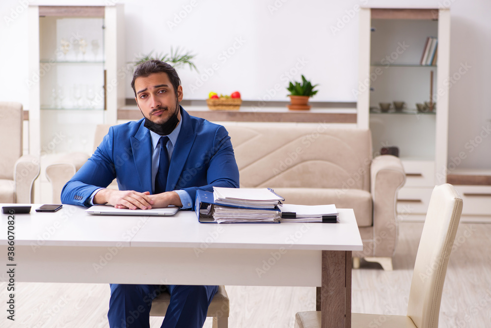 Young male employee in self-quarantine concept Young male employee in self-quarantine concept