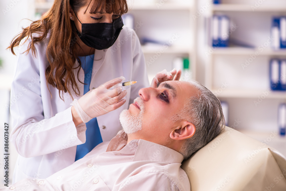 Old man visiting young female doctor for plastic surgery Old man visiting young female doctor for plastic surgery