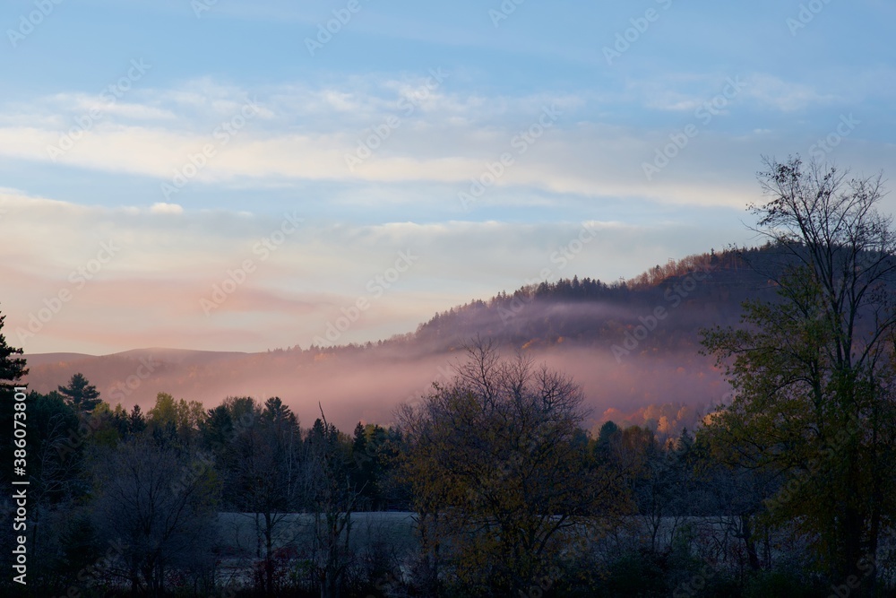 Pink mist over a hill on a cold morning in late fall