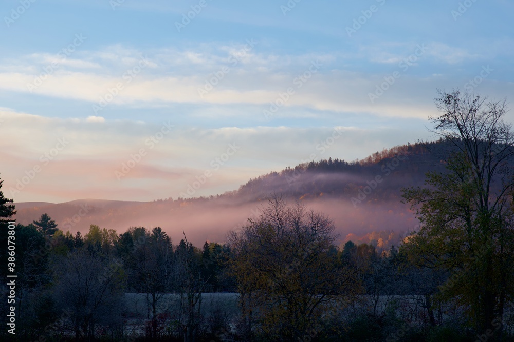 Pink mist over a hill on a cold morning in late fall Pink mist over a hill on a cold morning in late fall