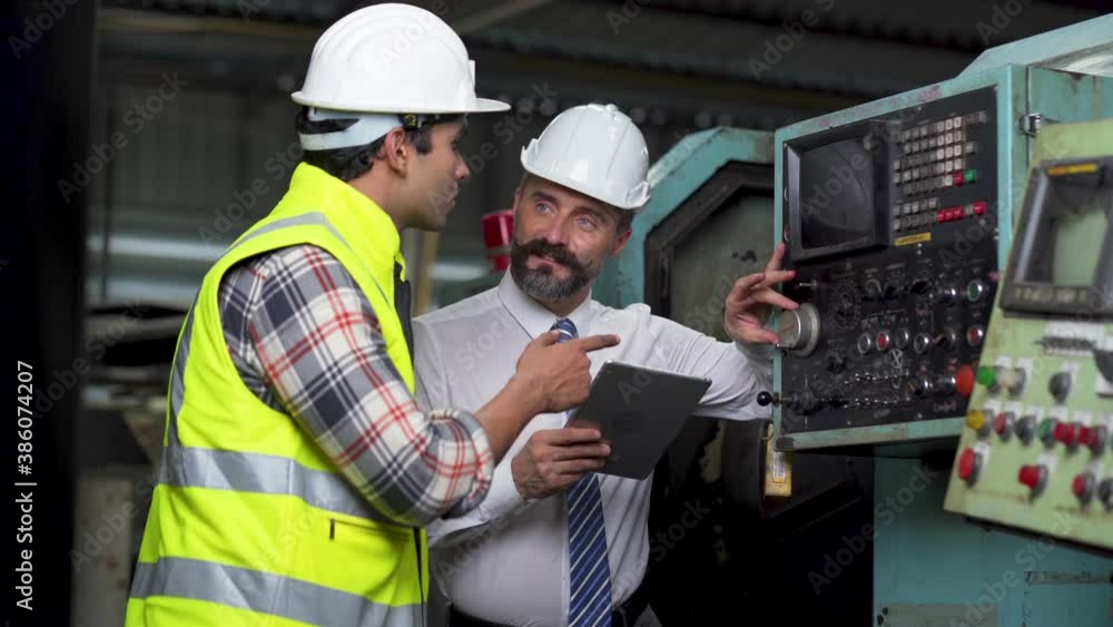 Engineering Worker team working in Heavy Industry Manufacturing Facility. Engineering Worker team working in Heavy Industry Manufacturing Facility.