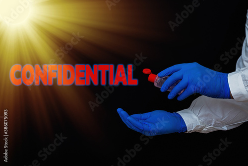 Conceptual hand writing showing Confidential. Concept meaning containing an individualal information whose unauthorized disclosure Displaying Sticker Paper Accessories With Medical Gloves On photo