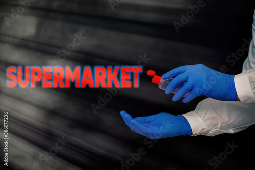 Conceptual hand writing showing Supermarket. Concept meaning organized selfservice shop offering wide variety of product Displaying Sticker Paper Accessories With Medical Gloves On photo