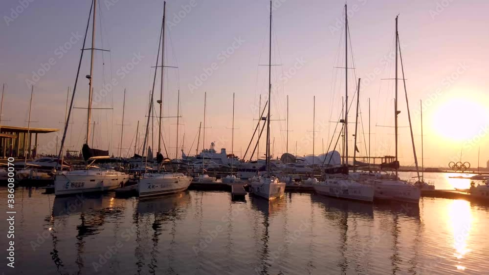 Qingdao, China, October 10, 2020: The dock of the Qingdao Olympic Sailing Center with a city view in the background. Qingdao, China, October 10, 2020: The dock of the Qingdao Olympic Sailing Center with a city view in the background.