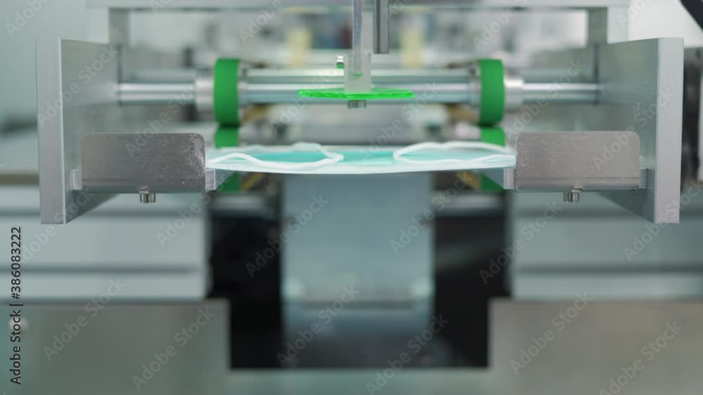 Machines are working for producing masks in a sterile factory. Production of medical masks. process of manufacturing a mask