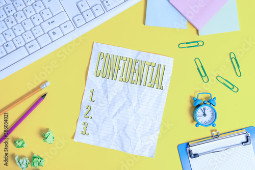 Writing note showing Confidential. Business concept for containing an individualal information whose unauthorized disclosure Flat lay above copy space on the white crumpled paper photo