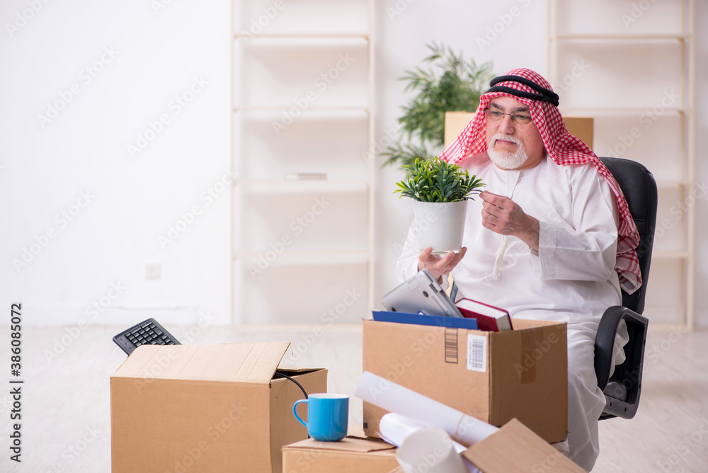 Old arab businessman in office relocation concept Old arab businessman in office relocation concept
