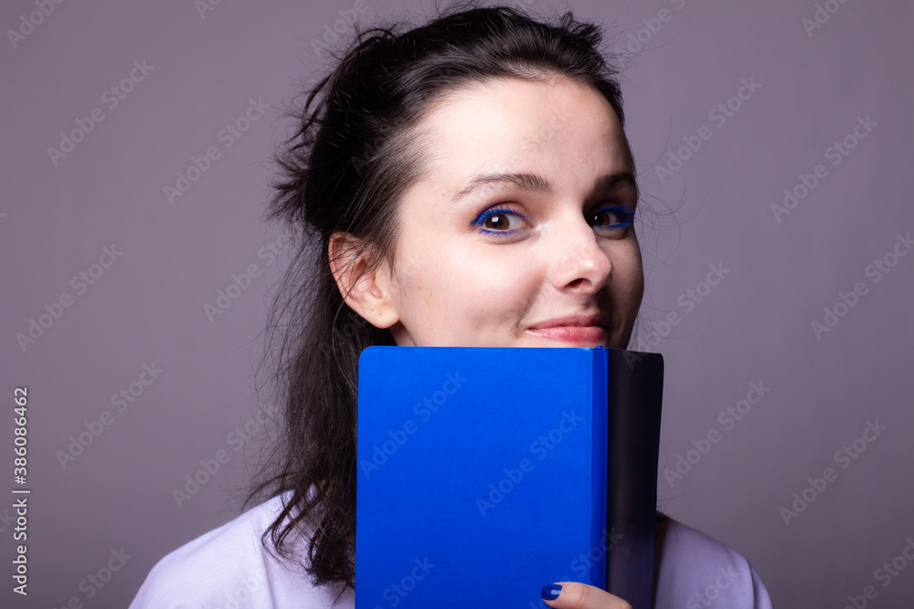woman student with blue notebook in hands woman student with blue notebook in hands