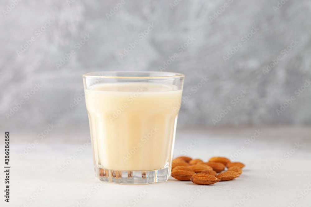 Vegan dairy free almond milk in bottle on gray background Vegan dairy free almond milk in bottle on gray background