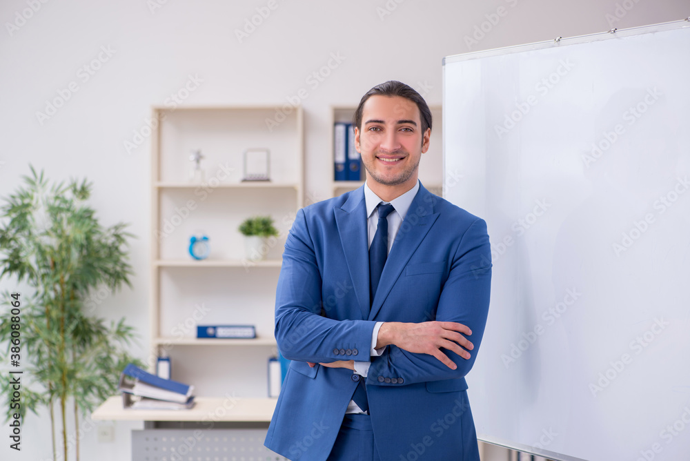 Fototapeta premium Young man employee in business presentation concept