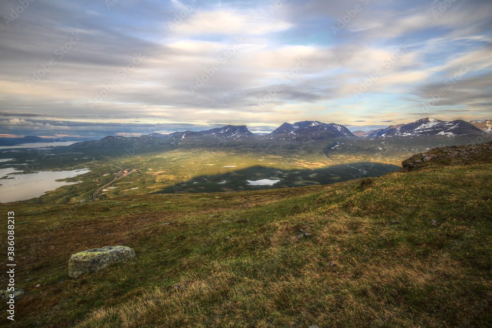 In summer nights here on Mount Nuolja, the mountain casts a shadow on Abisko valley