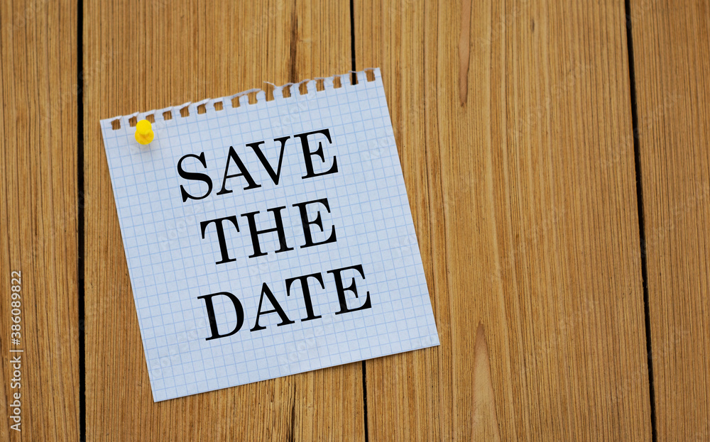 SAVE THE DATE - words on white paper attached to a wooden board SAVE THE DATE - words on white paper attached to a wooden board