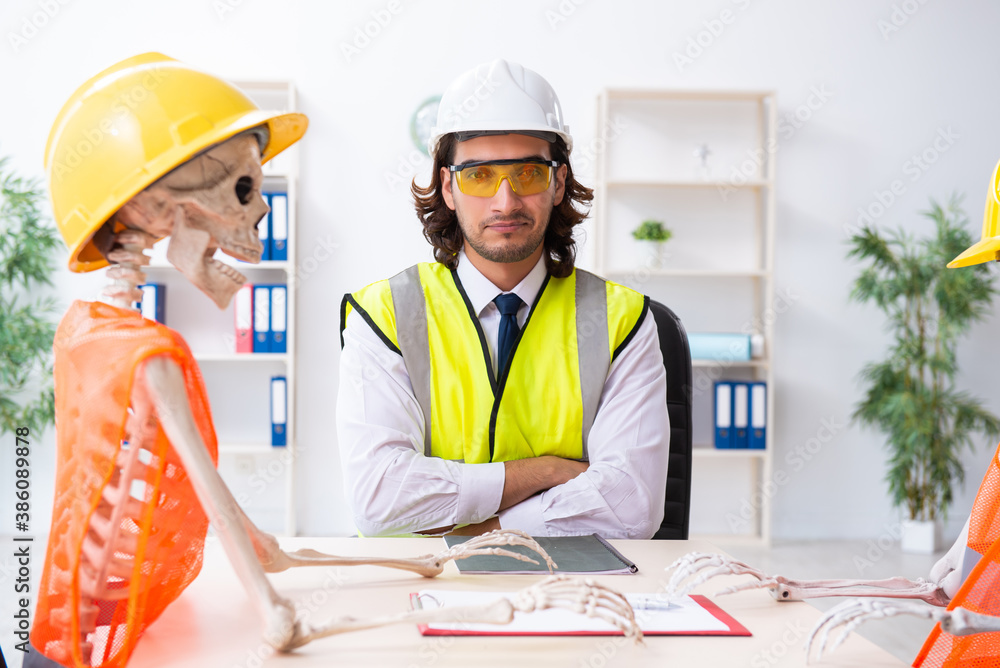Funny construction business meeting with boss and skeletons Funny construction business meeting with boss and skeletons