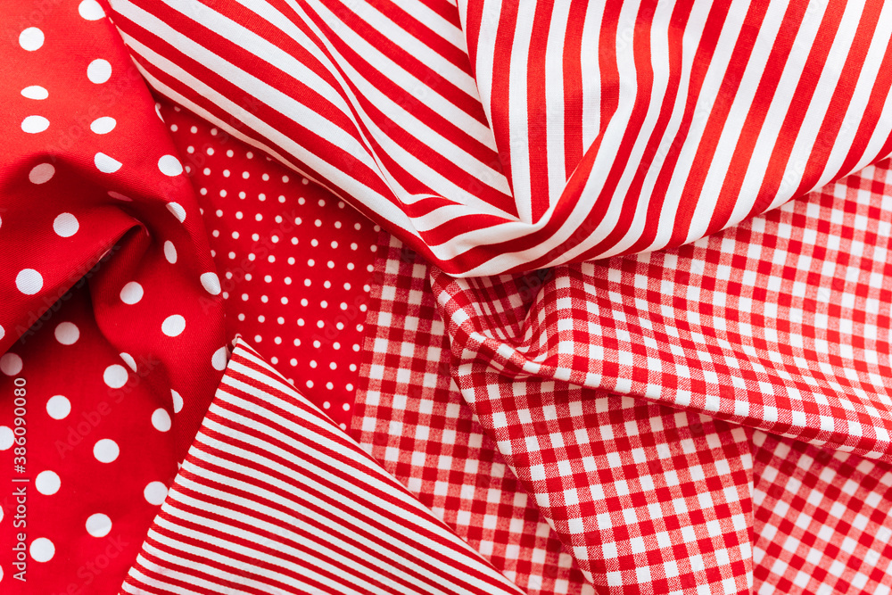 Obraz premium Background from a natural fabric in a red and white colors. Lay flat