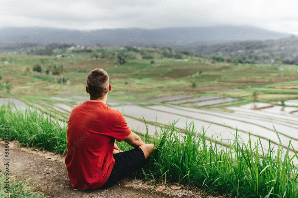 Young happy tourist enjoying the lovely view of the rice terrace in Bali, Indonesia. relaxed day in Tegalalang. Travel photograph. Lifestyle. Young happy tourist enjoying the lovely view of the rice terrace in Bali, Indonesia. relaxed day in Tegalalang. Travel photograph. Lifestyle.