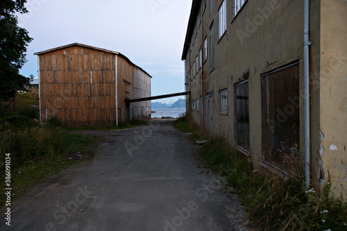 Old abandoned fishery housing and small road in Northern Norway 