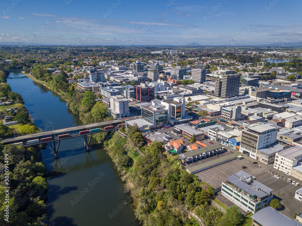 Aerial drone view looking at the CBD and CLaudelands Bridge over the Waikato River as it cuts through the city of Hamilton, in the Waikato region of New Zealand