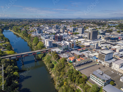 Aerial drone view looking at the CBD and CLaudelands Bridge over the Waikato River as it cuts through the city of Hamilton, in the Waikato region of New Zealand