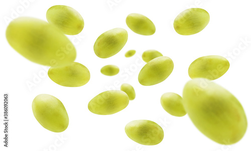 Green grapes levitate on a white background