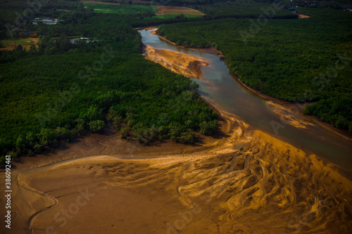 Blurred abstract background from high angle from plane window  overlooking the scenery below  river  mountain  tree .