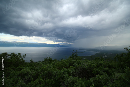 Sun and rain on lake Tornetrask, seen from mount Nuolja. 