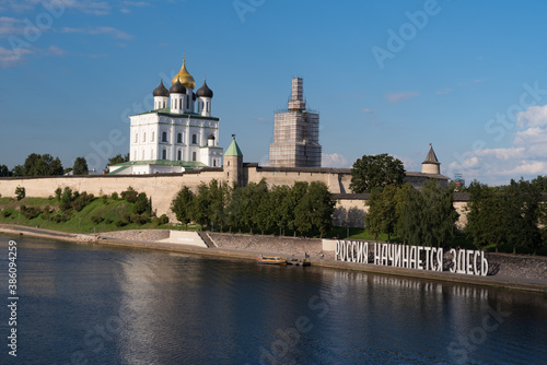 Bank of the Velikaya river. Installation "Russia begins here". Pskov Kremlin in the morning. Trinity cathedral, Pskov, Russia