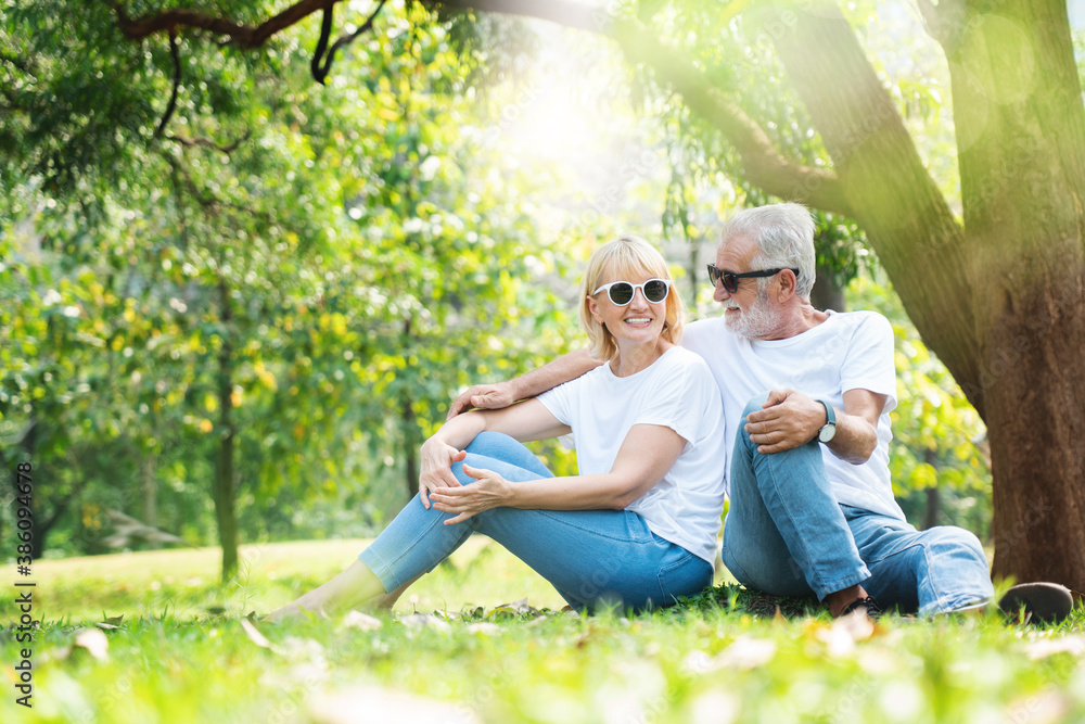 Fototapeta premium Portrait Senior family happy in the garden of summer. Lifestyle elderly Caucasian couple. Old man and the women come for a picnic With beautiful nature. Concept Health care insurance