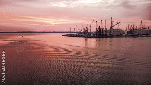 Industrial port in Rostock with cranes in dawn