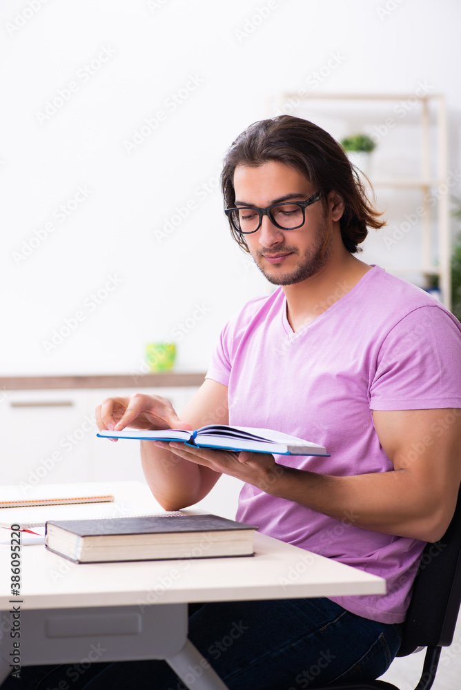 Young male student preparing for exams at classroom Young male student preparing for exams at classroom