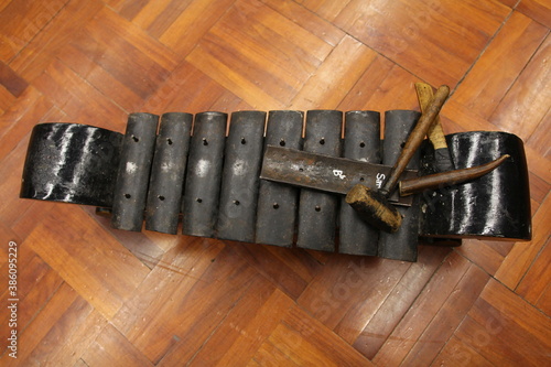 Gamelan Kiai Kanjeng. Traditional musical instruments from Indonesia. The frame is made of black painted wood, the blade is made of black iron photo