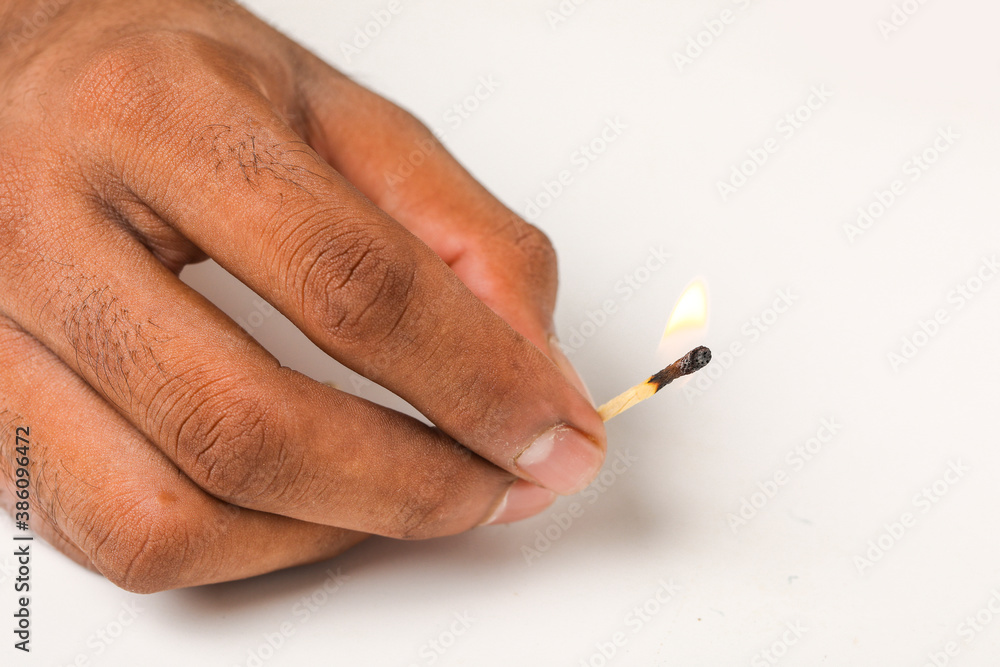 burning match in hand on white background burning match in hand on white background