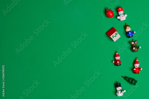 Christmas background wooden toys on green background copy space text top view