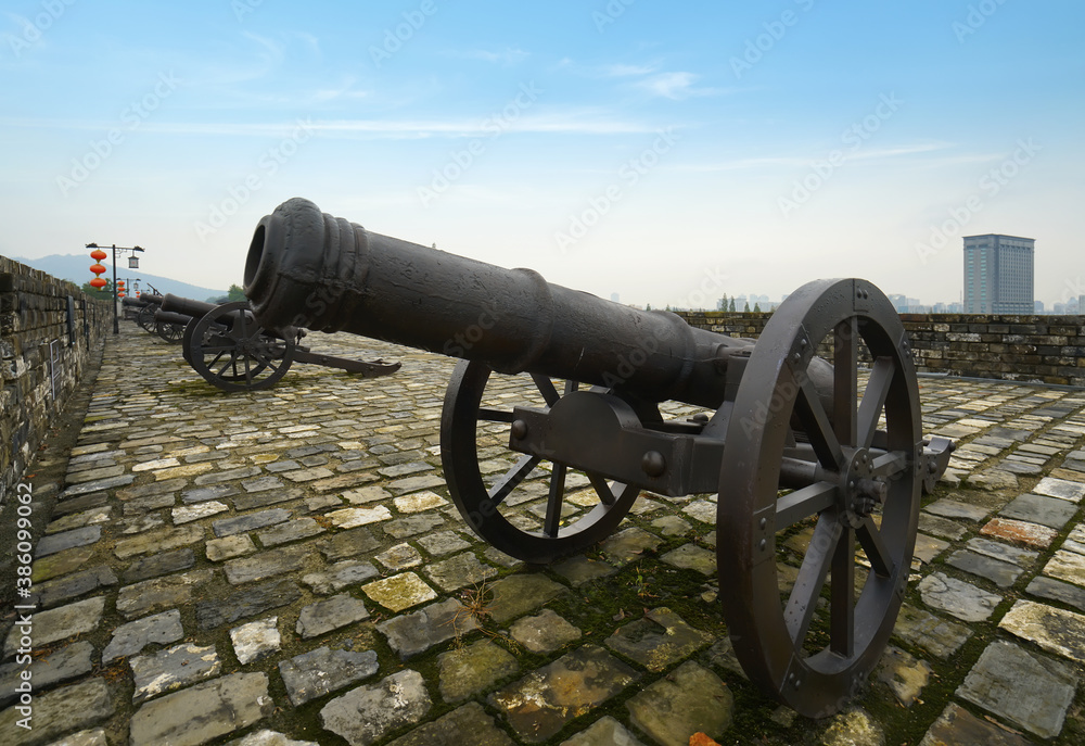 The ancient cannon is on the wall