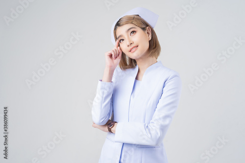 Portrait of a beautiful Asian nurse pointing fingers thinking