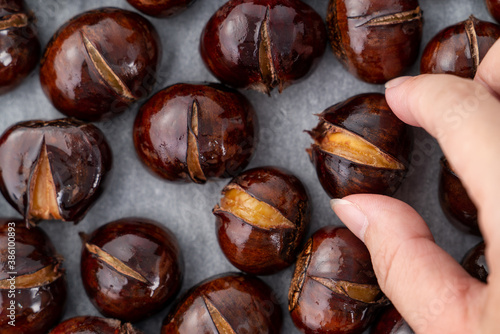 Close up of delicious roasted chestnuts with oil for eating.