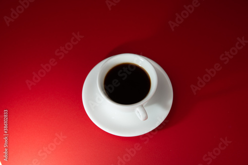 cup of coffee on the red background. Americano.