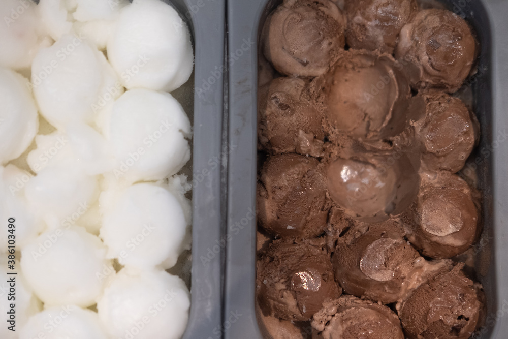 Scoop chocolate ice cream and coconut milk ice cream in box Scoop chocolate ice cream and coconut milk ice cream in box
