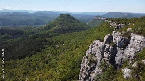 Beautiful aerial view of the steep high cliffs, covered with green forest. Bakhchisaray, Crimea.